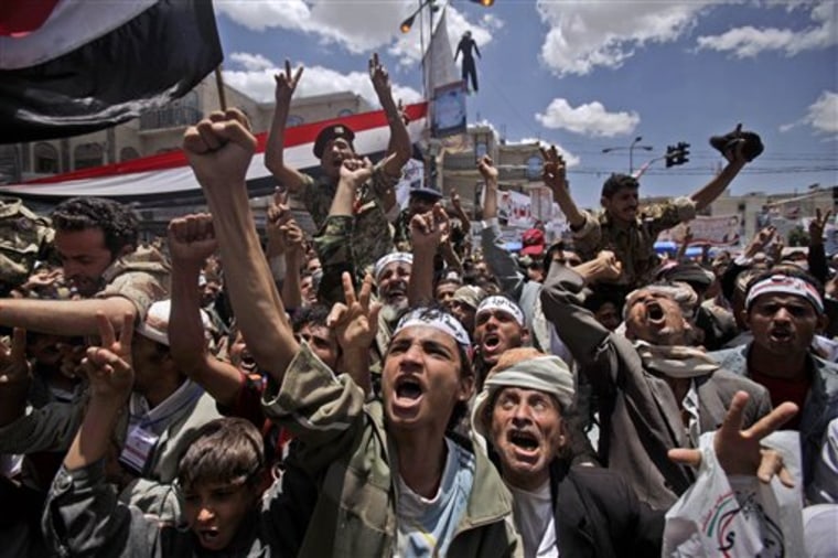Anti-government protesters shout slogans during a demonstration demanding the resignation of Yemeni President Ali Abdullah Saleh, in Sanaa, Yemen, on April 25. Forces loyal to Yemen's embattled president attacked protesters calling for his ouster in a southern city Monday, injuring dozens, according to an opposition activist. 